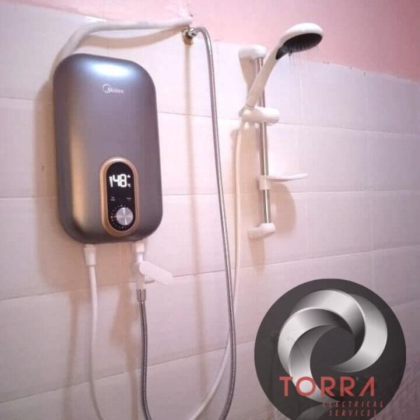 An installed tankless Midea brand instant water heater in a bathroom with water running